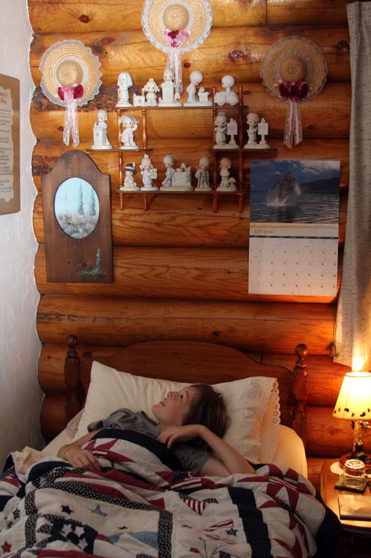 Zac weirded out by figurines over his head at the Cozy Log B&B