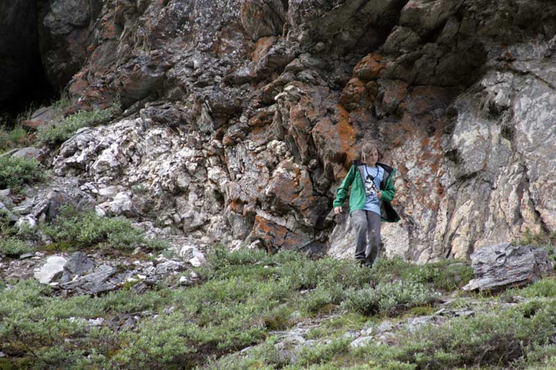 Zac runs down from a cave in the rock above the Savage River
