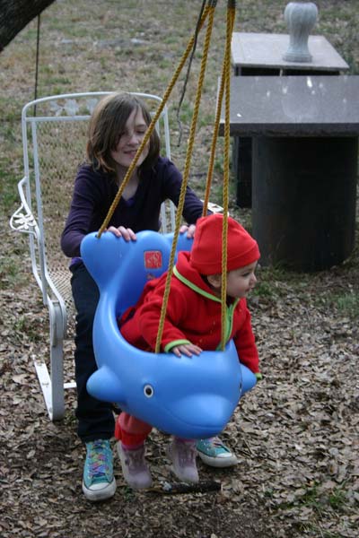 Zac pushes Sofia on swing