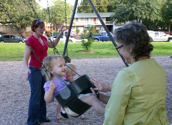 Nana pushing Lucy swinging