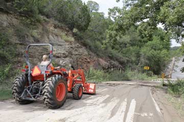 Jan and her tractor clear the mud