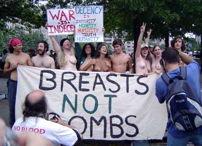 Men & women reveal all and display their banner that says "Breasts not Bombs"