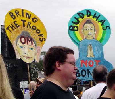 Signs say "Buddhas Not Bombs" & "Bring the Troops Om".