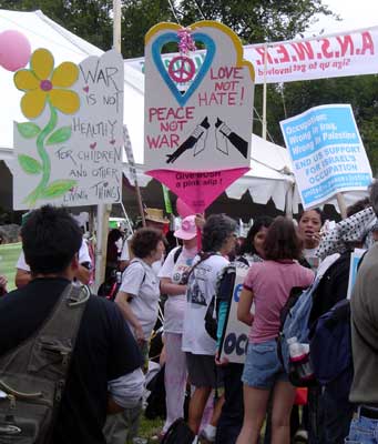 Cutout signs say "War is Not Healthy for..." and "Love not Hate"