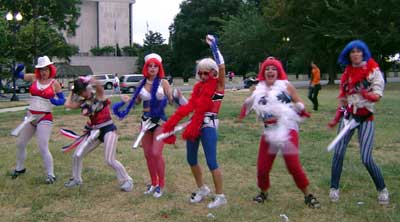 Women wearing red, white and blue as well as huge rocket dildos sing satirical songs.